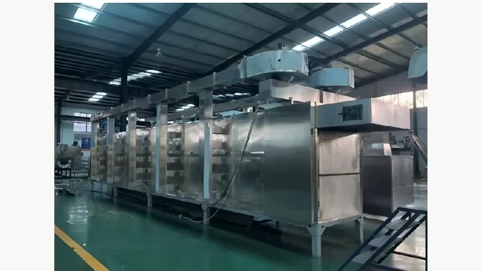 Industrial belt dryer representing the thermal stage that must match extruder throughput
